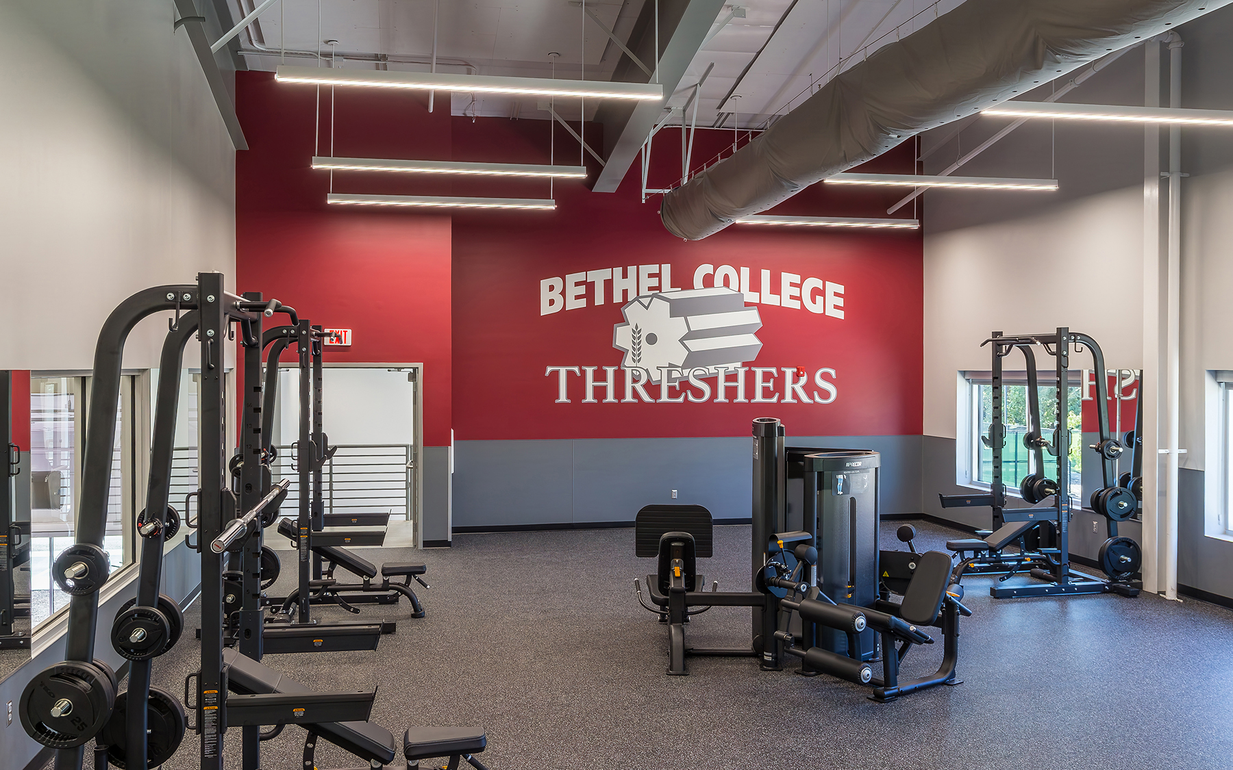 Bethel College weight room with red wall.