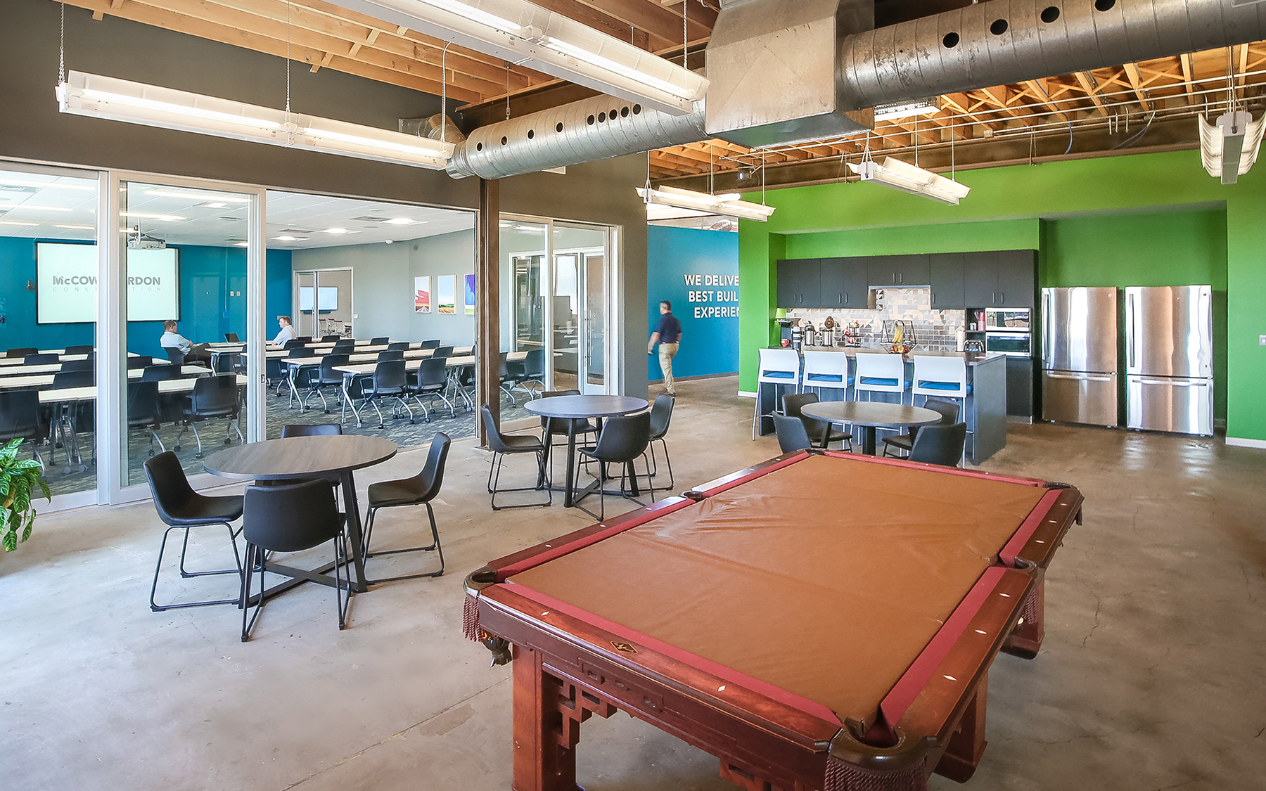 Pool table lounge area and view of kitchen.